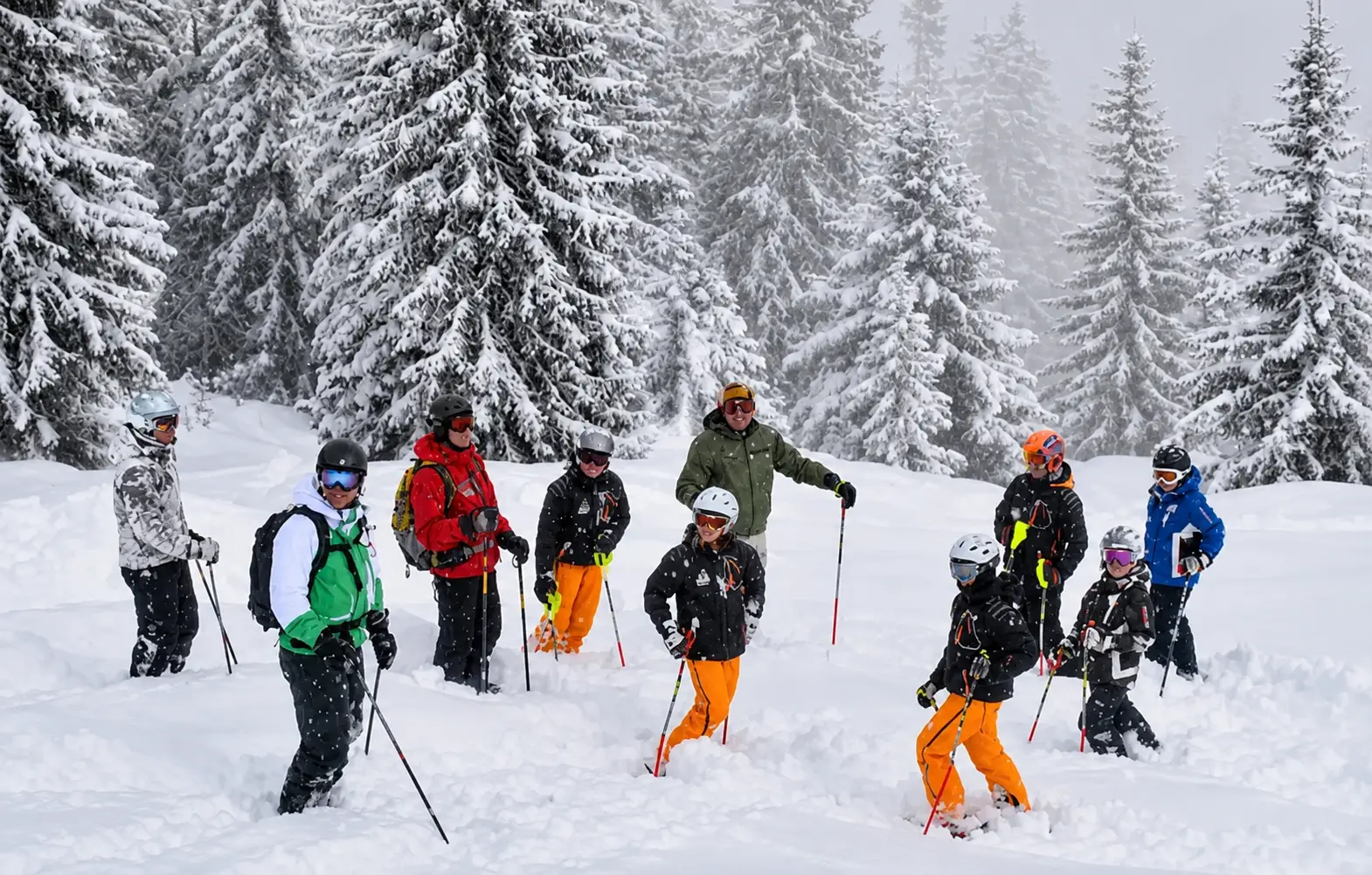 Young skiers and guides in a snow-covered alpine forest