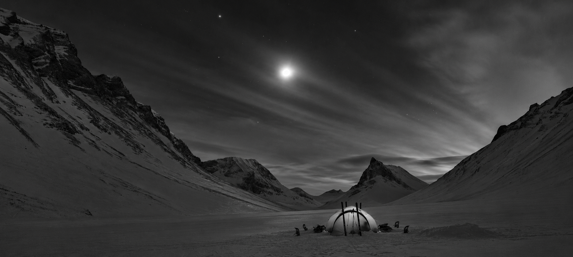 An alpine valley beneath a moonlit sky